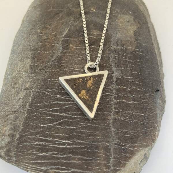 Triangular necklace hanging from offset jump-ring. Sterling silver, coffee, gold leaf.