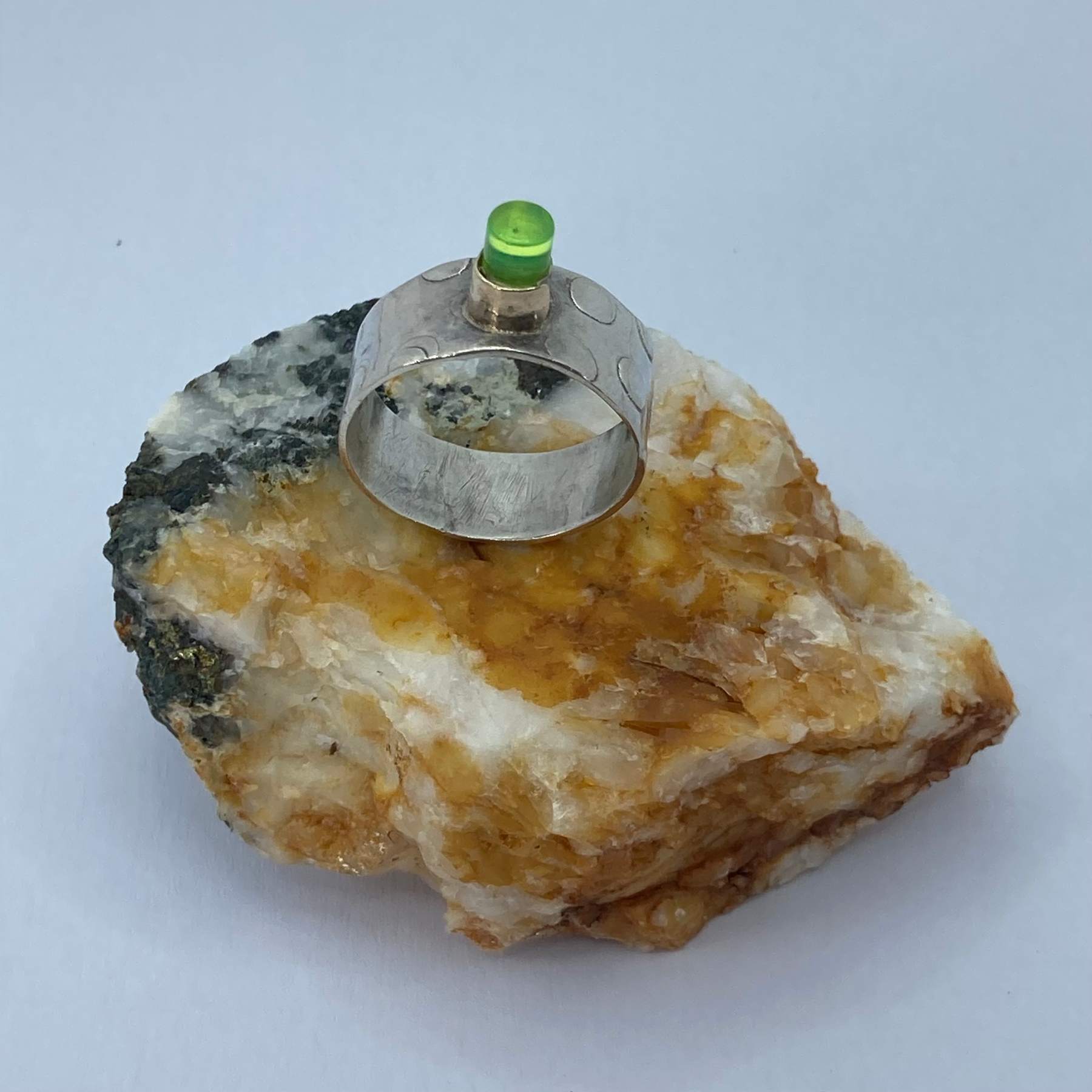 Ring, imprinted texture silver band, gold setting, flouro green perspex